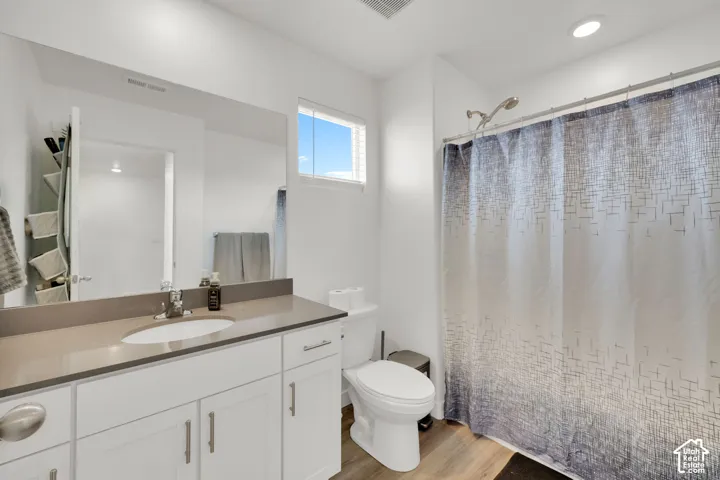 Single vanity with a light gray countertop, undermount sink, and chrome faucet
