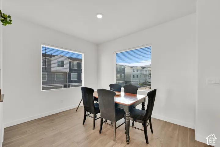 Recessed lighting, wood-finish flooring, and white walls