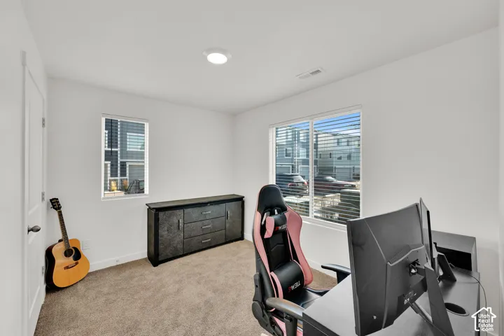 Recessed ceiling lighting, carpet flooring, and two windows with horizontal blinds