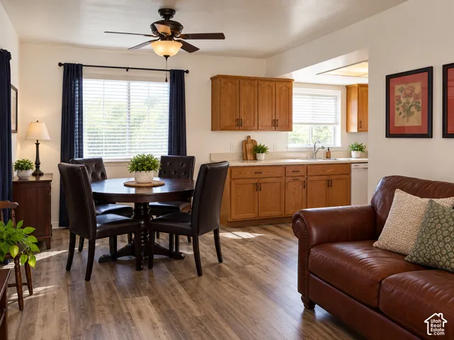Wood-finish flooring throughout, with a dining area featuring a ceiling fan with integrated lighting