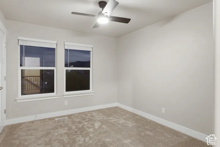 Neutral-toned walls complement the textured carpeting