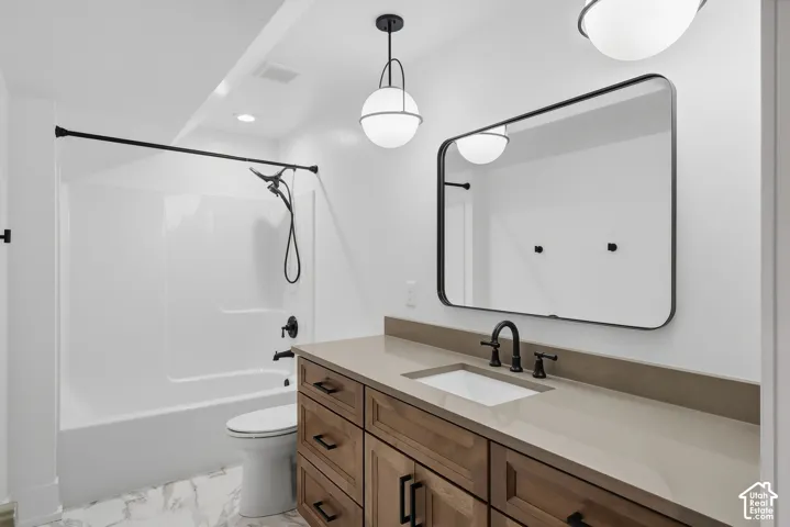 White bathtub and shower combination with matte black fixtures