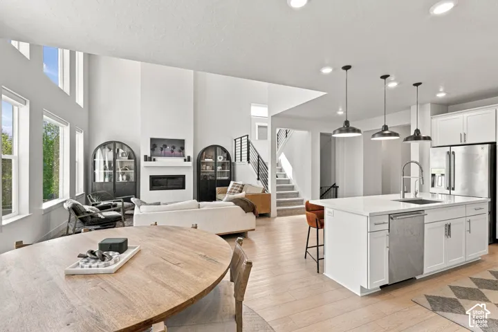 Open-concept living space featuring high ceilings, a fireplace, and multiple windows