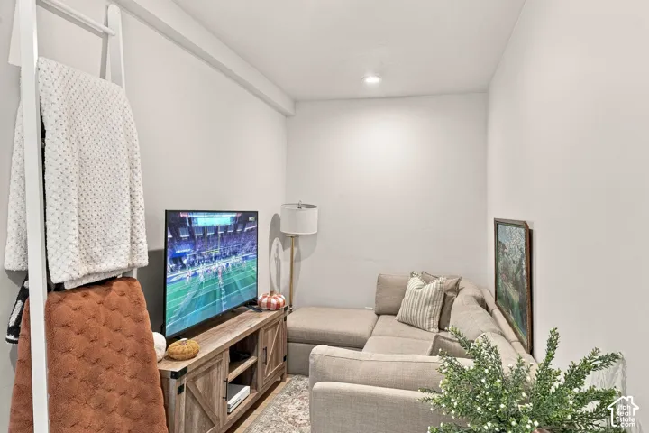 Recessed lighting, wood-finish media console, and light neutral wall colors