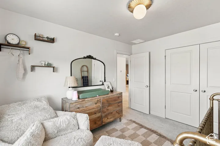Bright room with light-toned carpeting and white walls