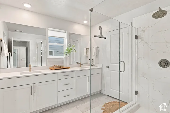 Dual vanity with white cabinetry, quartz countertops, and undermount sinks