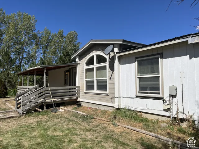 Covered porch with wooden railings and steps