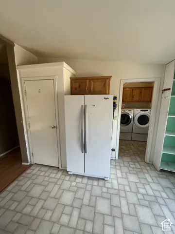 Laundry area with wood-finish cabinetry and built-in shelving