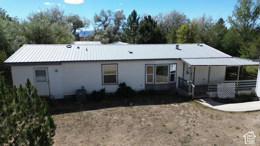 Metal roof with covered porch and bay window