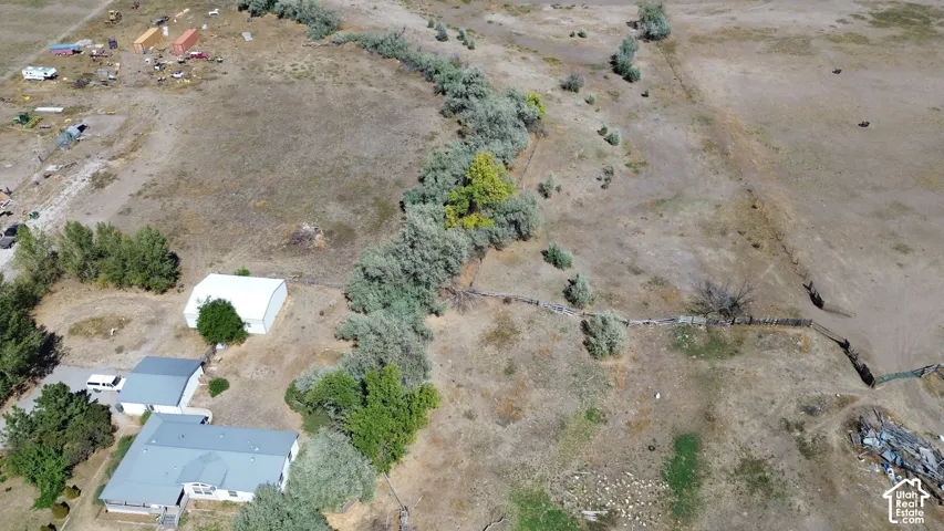 Expansive land with multiple structures and mature trees