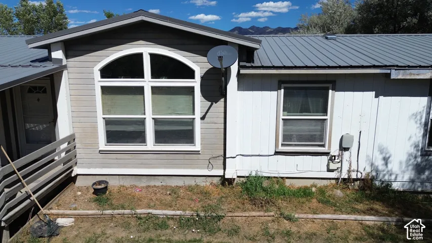 Metal roofing and siding exterior featuring an arched window