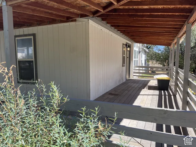 Covered wood deck with exposed wood beam ceiling