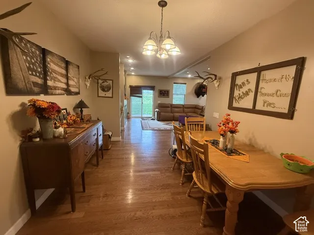 Hardwood flooring, recessed lighting, and a pendant light fixture