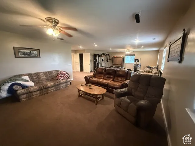 Recessed lighting, ceiling fan light fixture, brown carpet flooring, and white interior doors