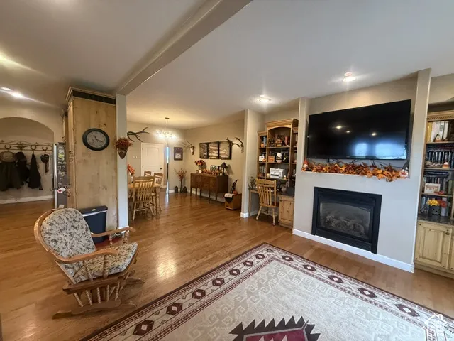 Hardwood flooring throughout, recessed lighting, built-in fireplace, and custom built-in cabinetry