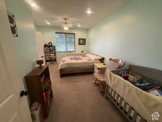 Recessed ceiling lighting, ceiling fan light fixture, light-toned wall paint, window with blinds, and light-toned carpeting