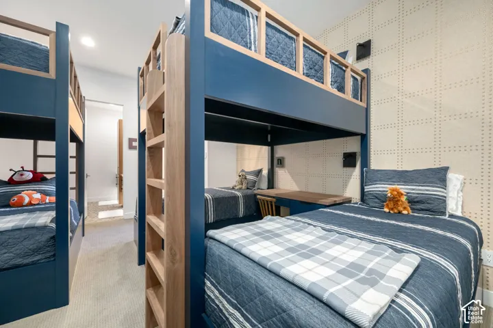 Custom built-in bunk beds with integrated ladders and wood-finish desk