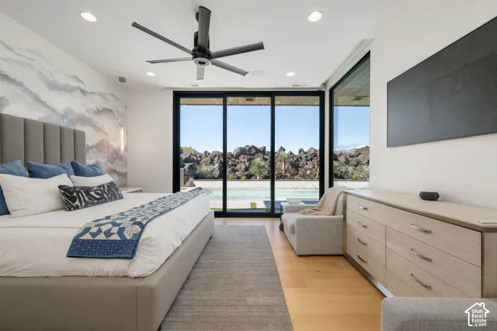 Recessed lighting, wood-finish flooring, and a contemporary ceiling fan