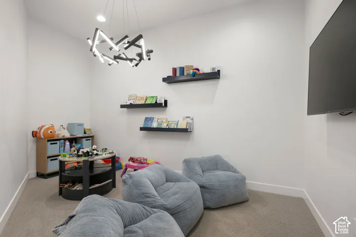 Recessed lighting, wall-mounted display shelves, and a contemporary chandelier