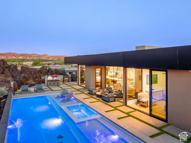 Modern exterior with a rectangular pool, integrated spa, and concrete patio