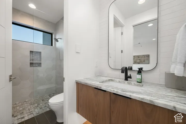 Floating wood-finish vanity with an integrated sink and stone countertop