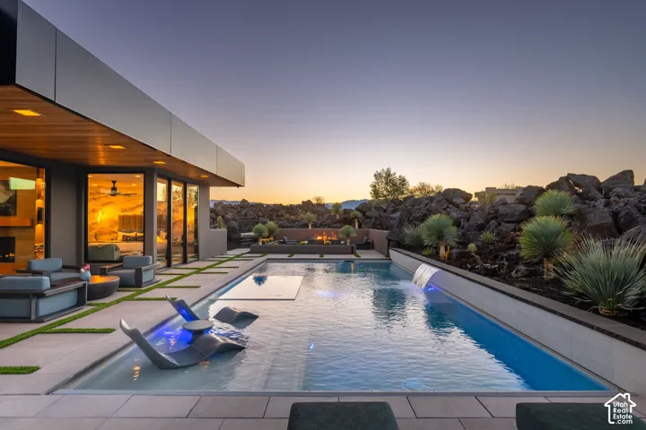 Modern exterior with a large swimming pool featuring water features