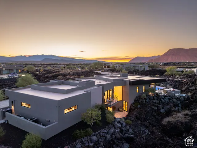 Modern architectural design featuring expansive glass panels, a flat roofline, and multiple outdoor terrace areas