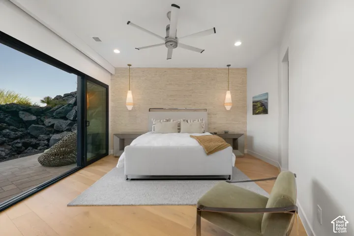 Light wood-finish flooring, recessed lighting, and a modern ceiling fan