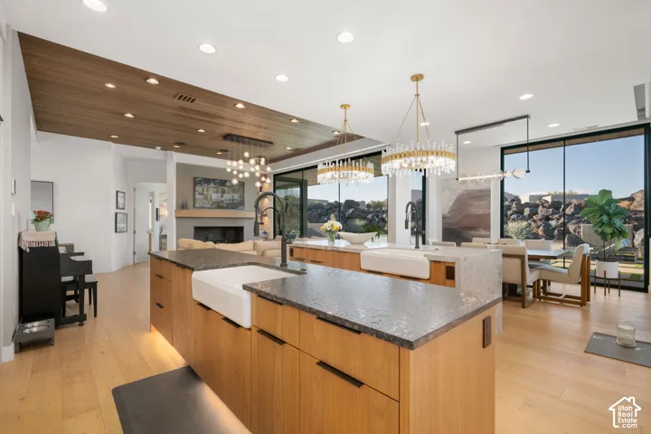 Open-concept living space with wood-finish flooring, a wood-paneled ceiling accent, and recessed lighting