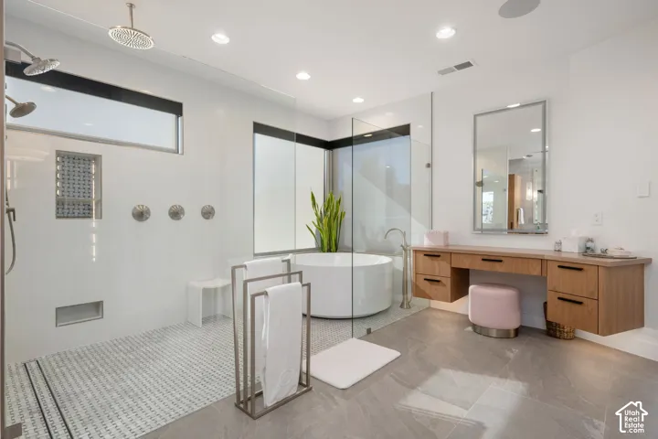 Glass-enclosed shower with dual shower heads and a rainfall shower head