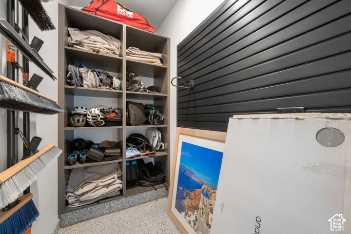 Built-in shelving unit, slatwall storage system, and speckled epoxy flooring