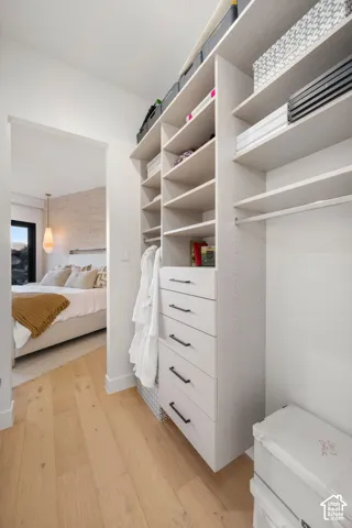 Custom closet system featuring built-in shelving, integrated drawers with dark hardware, and hanging rods