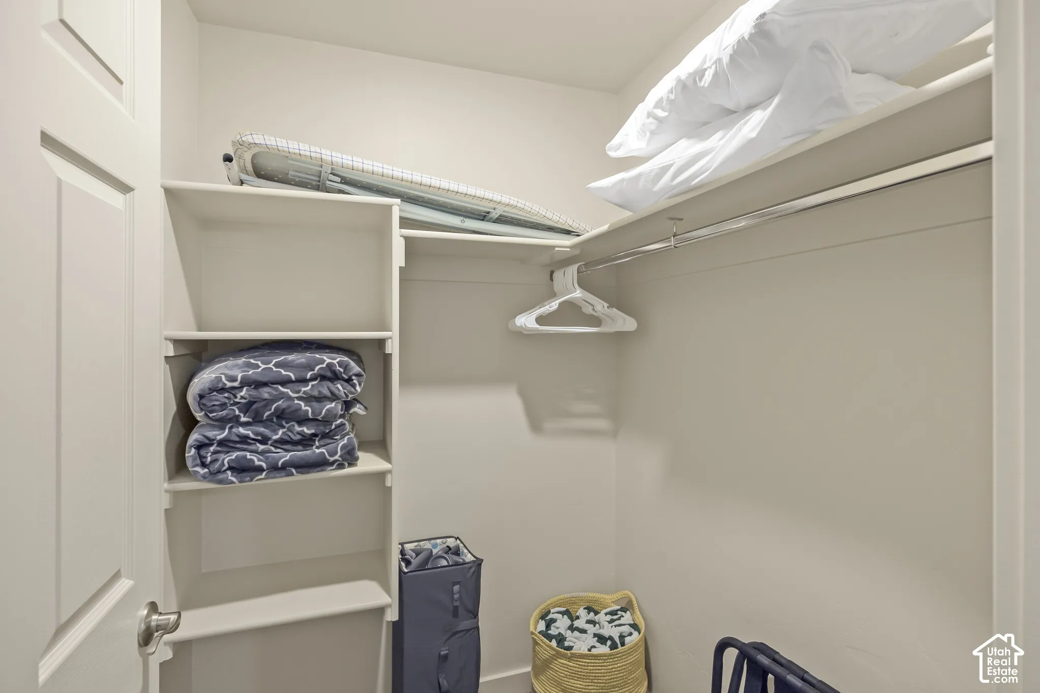Built-in shelving, overhead storage, and a clothes rod for organization