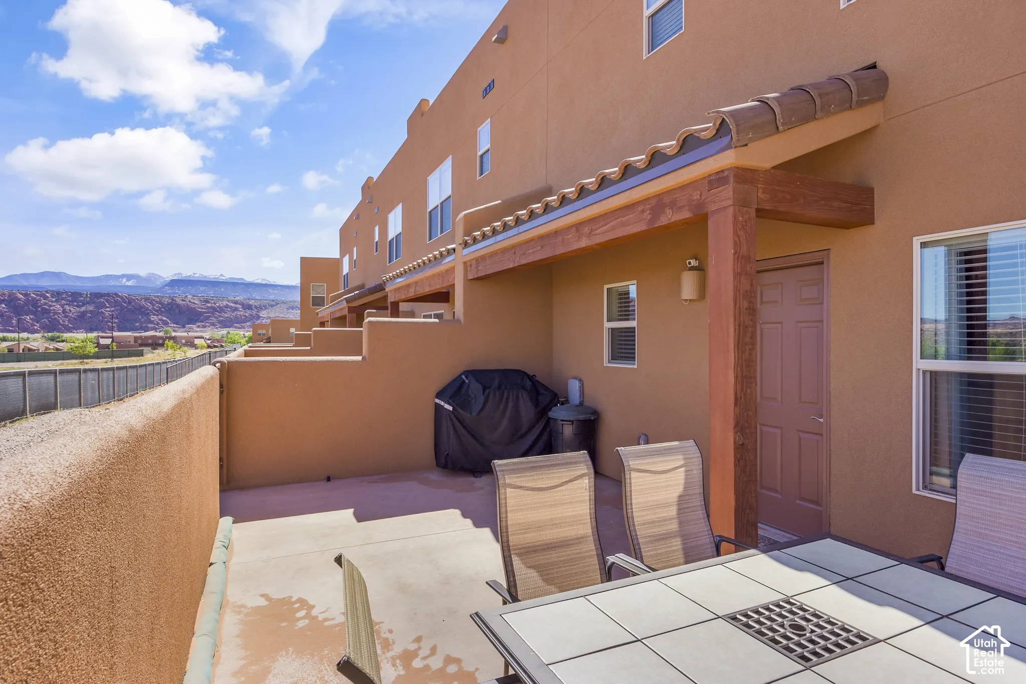 Terracotta-colored stucco exterior with a covered patio area
