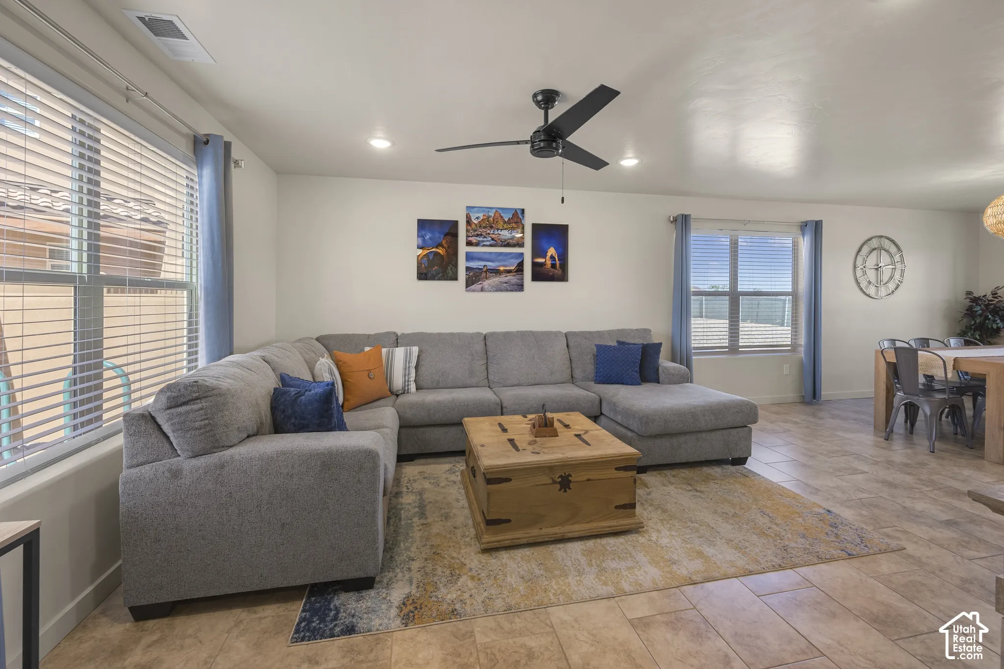 Recessed lighting, ceiling fan, large windows with blinds, and tile flooring