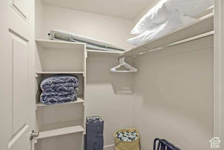 Built-in shelving, overhead storage, and a clothes rod for organization