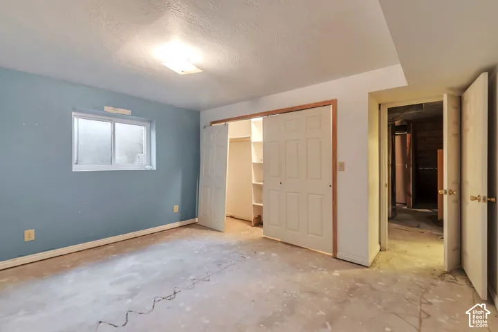 Window with white framing, light blue wall paint, white trim, sliding closet doors, built-in closet shelving