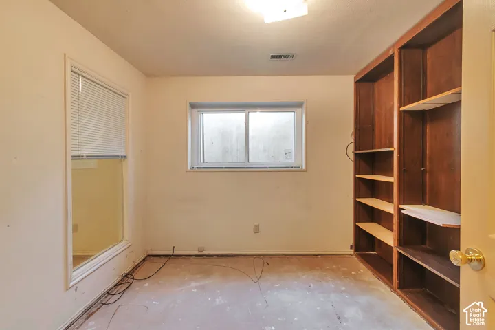 Built-in shelving, two windows, and overhead lighting