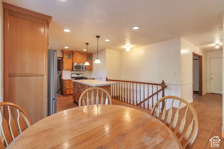 Kitchen featuring wood-finish cabinetry, stainless steel appliances, and an island with countertop space
