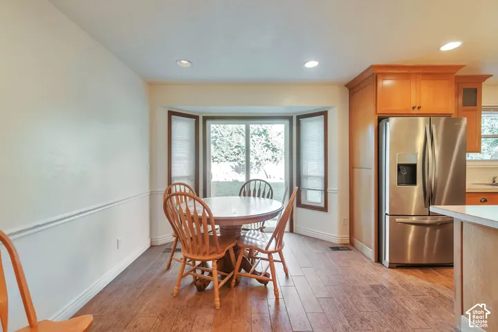 Wood-finish flooring, recessed lighting, and a bay window featuring a wood trim