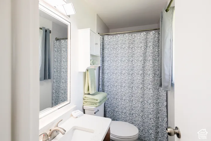 Primary bathroom - new LVP floor, quartz countertop, sink and faucet, and shower