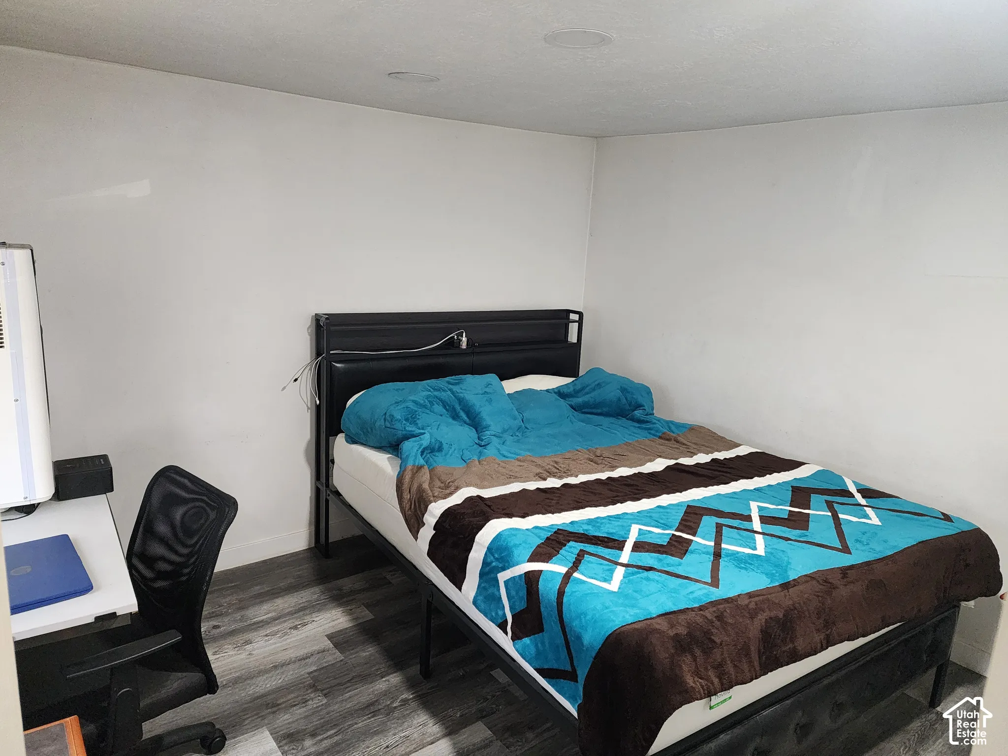 Recessed ceiling lighting, wood-finish flooring, and white painted walls