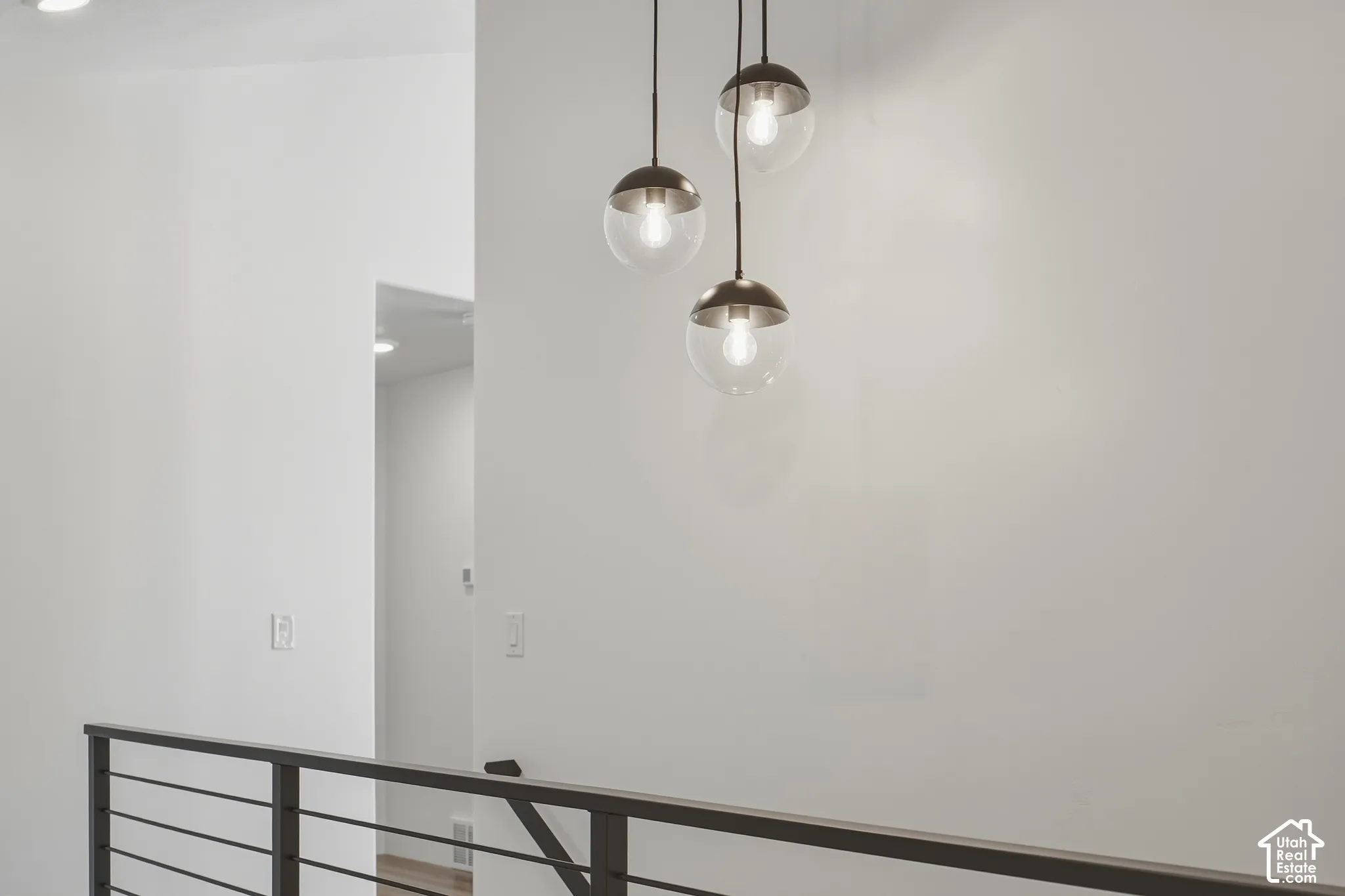 Modern linear chandelier with spherical glass shades and metal accents
