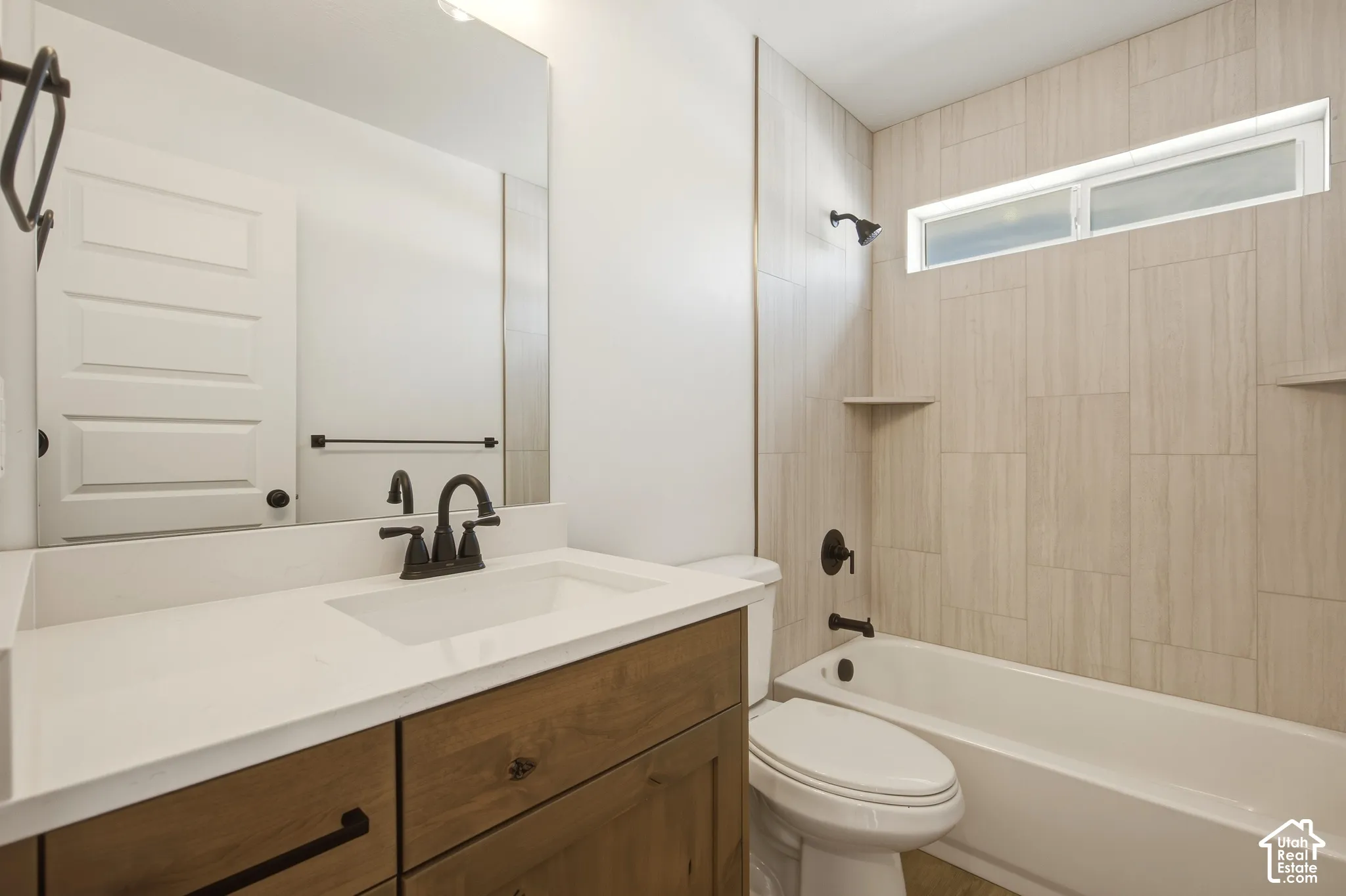 White rectangular bathtub with dark bronze fixtures
