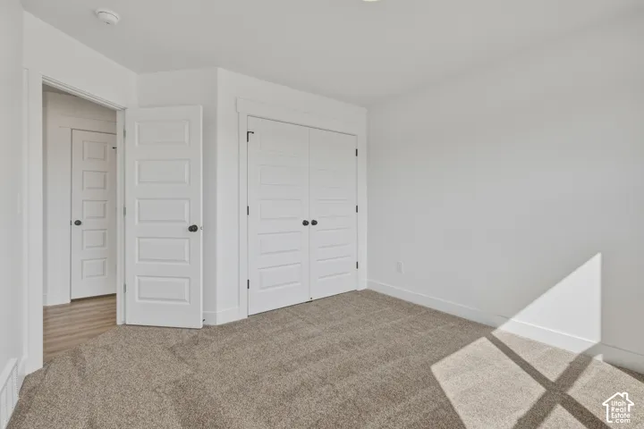 Wall-to-wall carpeting with multiple panel interior doors and contrasting black hardware