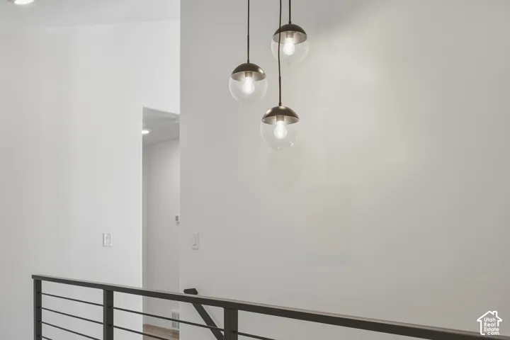 Modern linear chandelier with spherical glass shades and metal accents