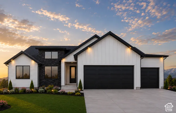 Contemporary exterior featuring white vertical and horizontal siding, dark stone accent cladding, and black-framed windows