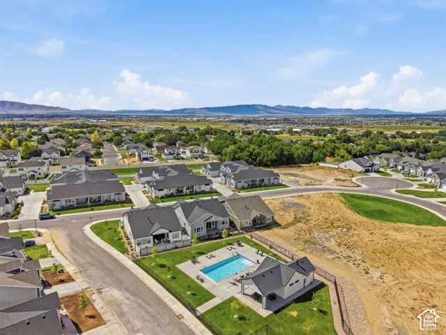 Community pool with a dedicated pool house, surrounded by residential properties and open spaces