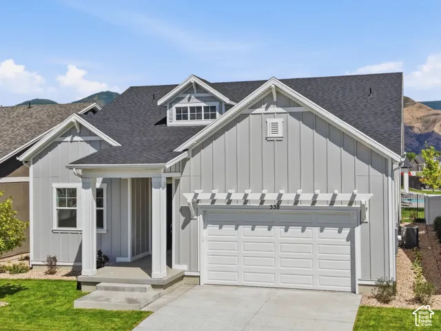 Contemporary exterior with light gray siding and dark roof
