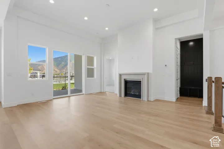 Light wood-finish flooring with recessed lighting